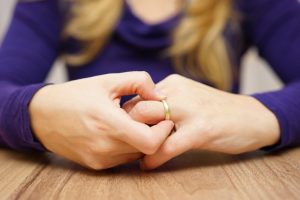 woman taking off wedding ring