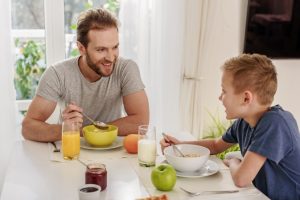 father and son eating breakfast