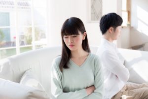 couple facing away from each other on couch