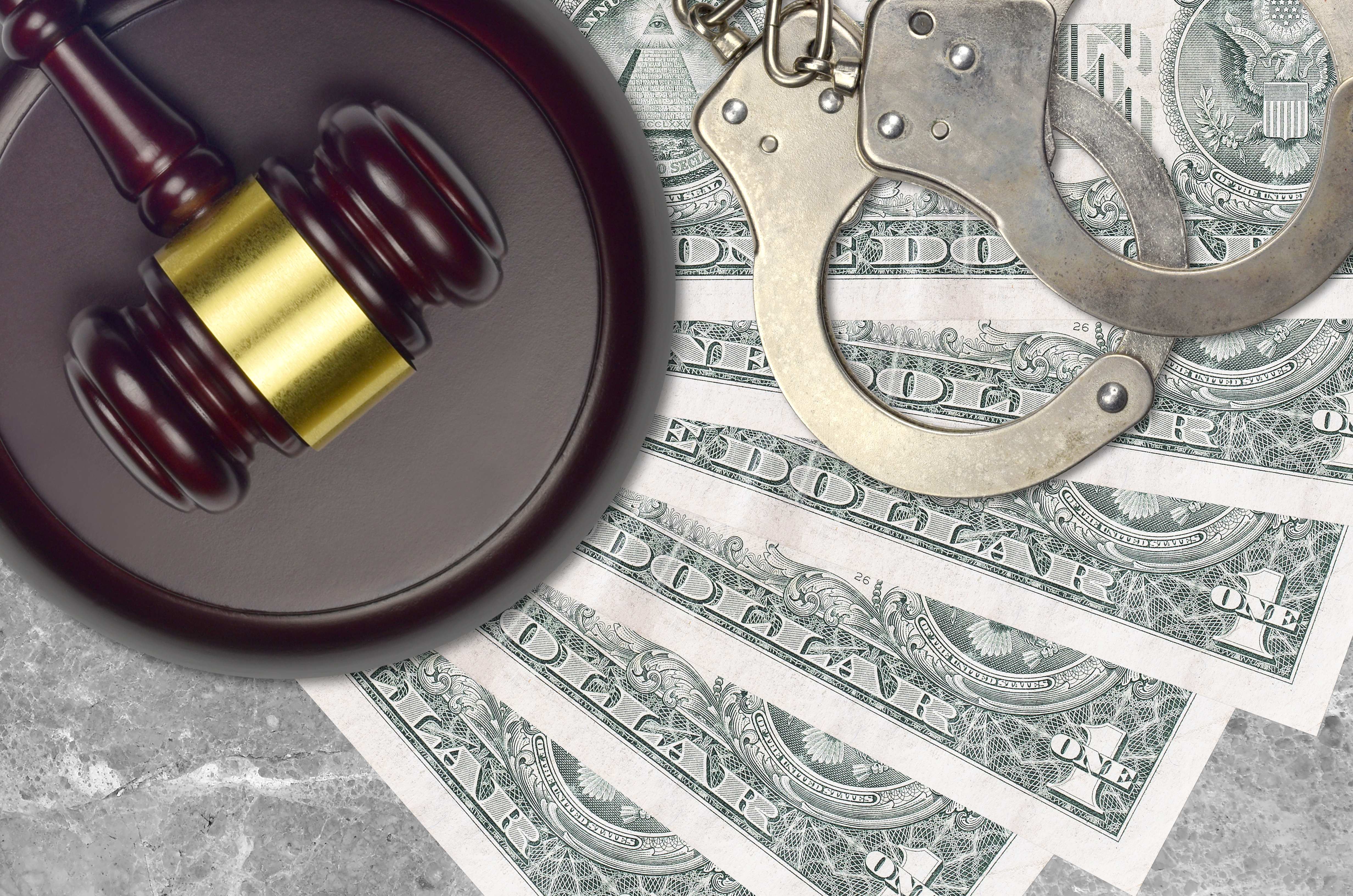 Judge gavel, dollar bills, and handcuffs representing a DUI defense FAQ Florida case