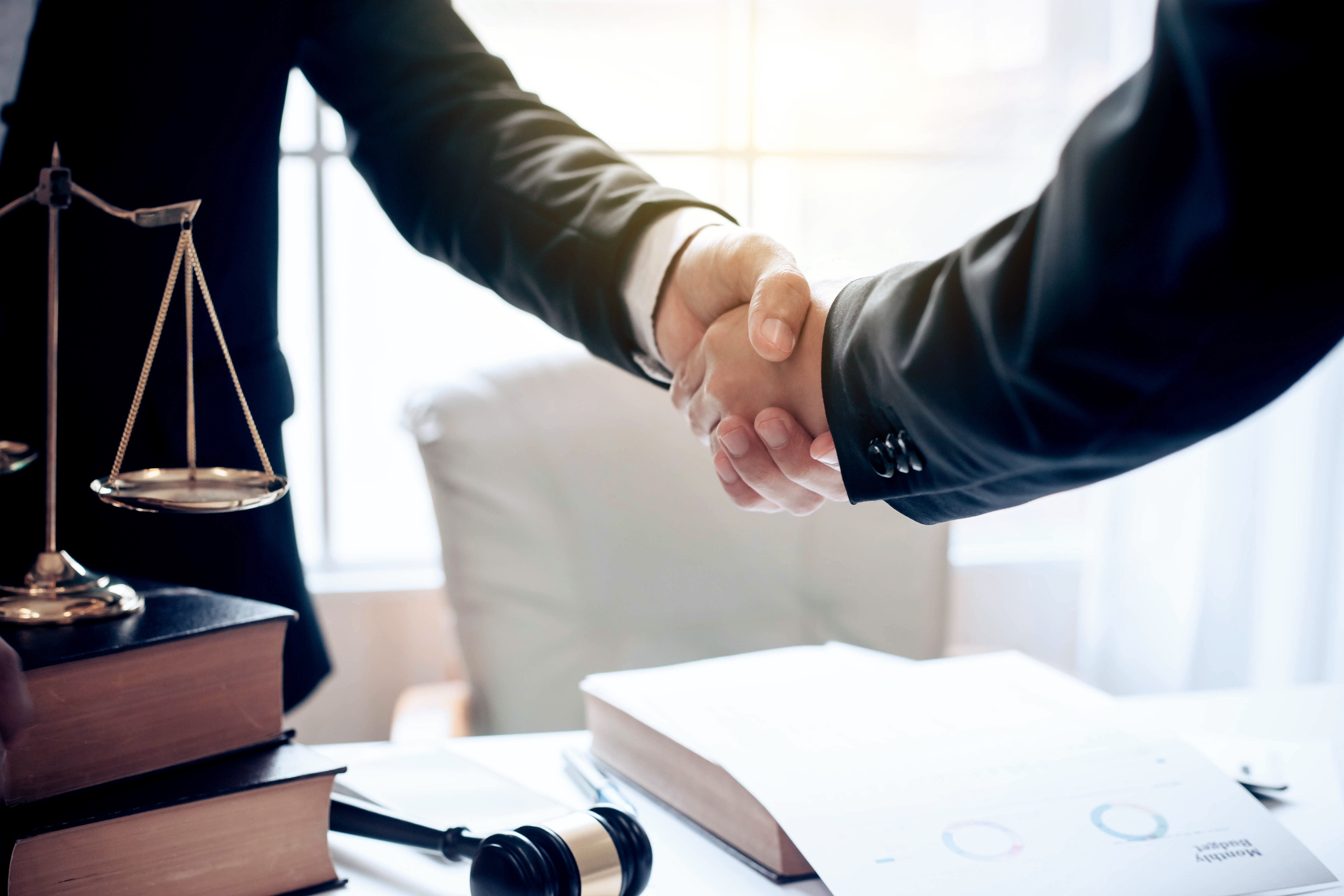 Divorce attorney in Tampa Florida shaking hands with client over legal documents