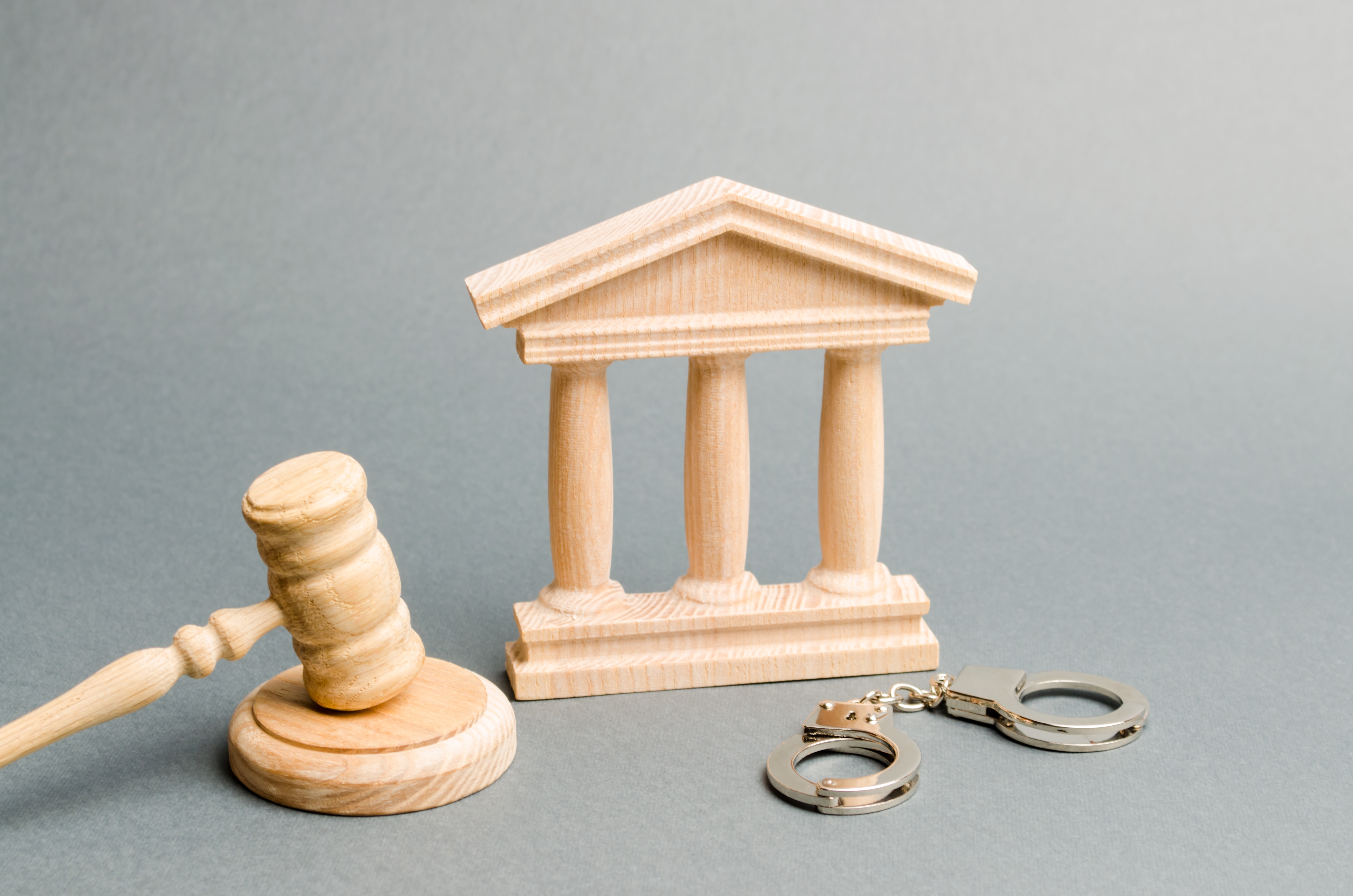 Handcuffs resting near a Florida courthouse, representing a criminal defense consultation Florida