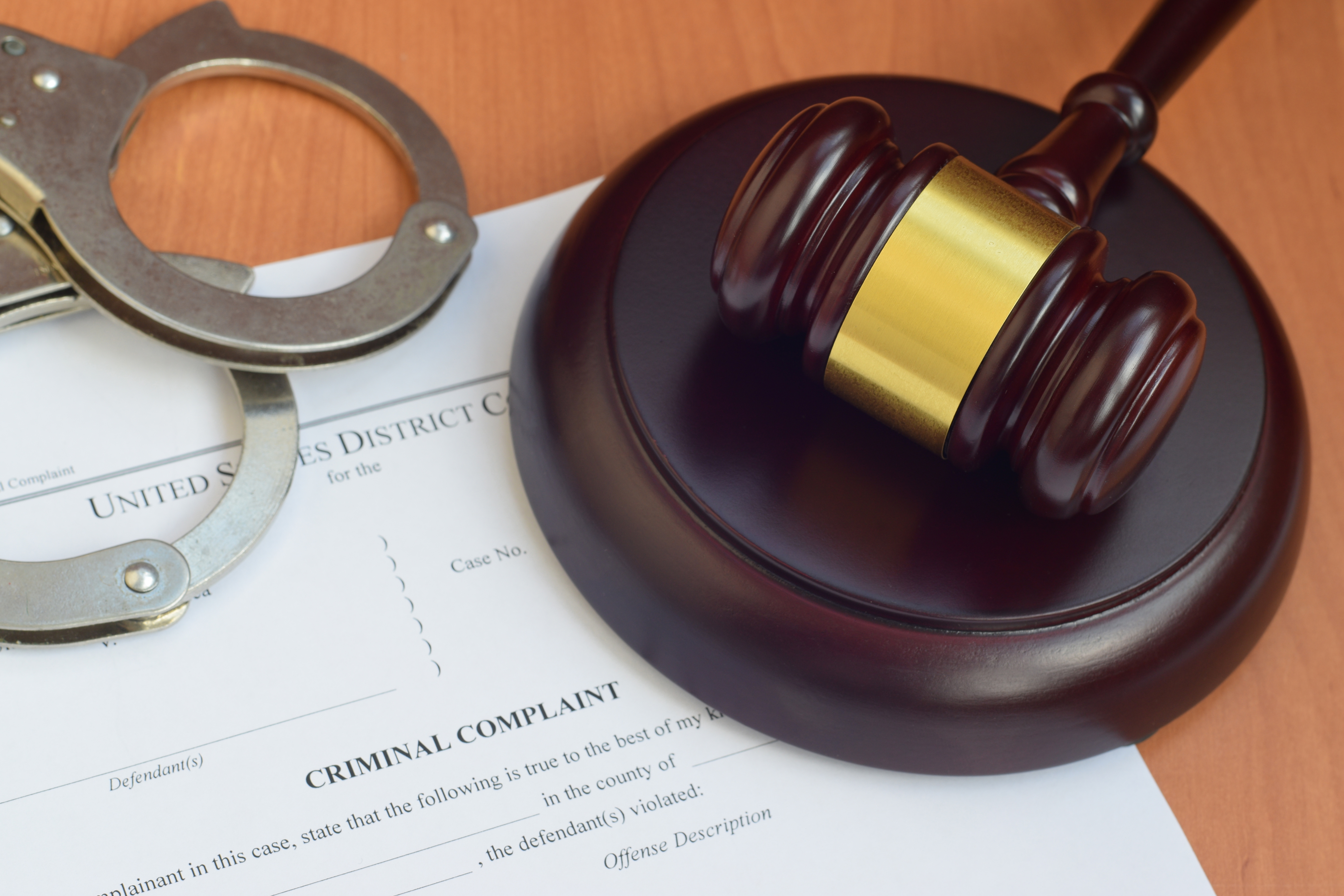 Gavel resting on criminal complaint document, representing drug charge Florida warning signs