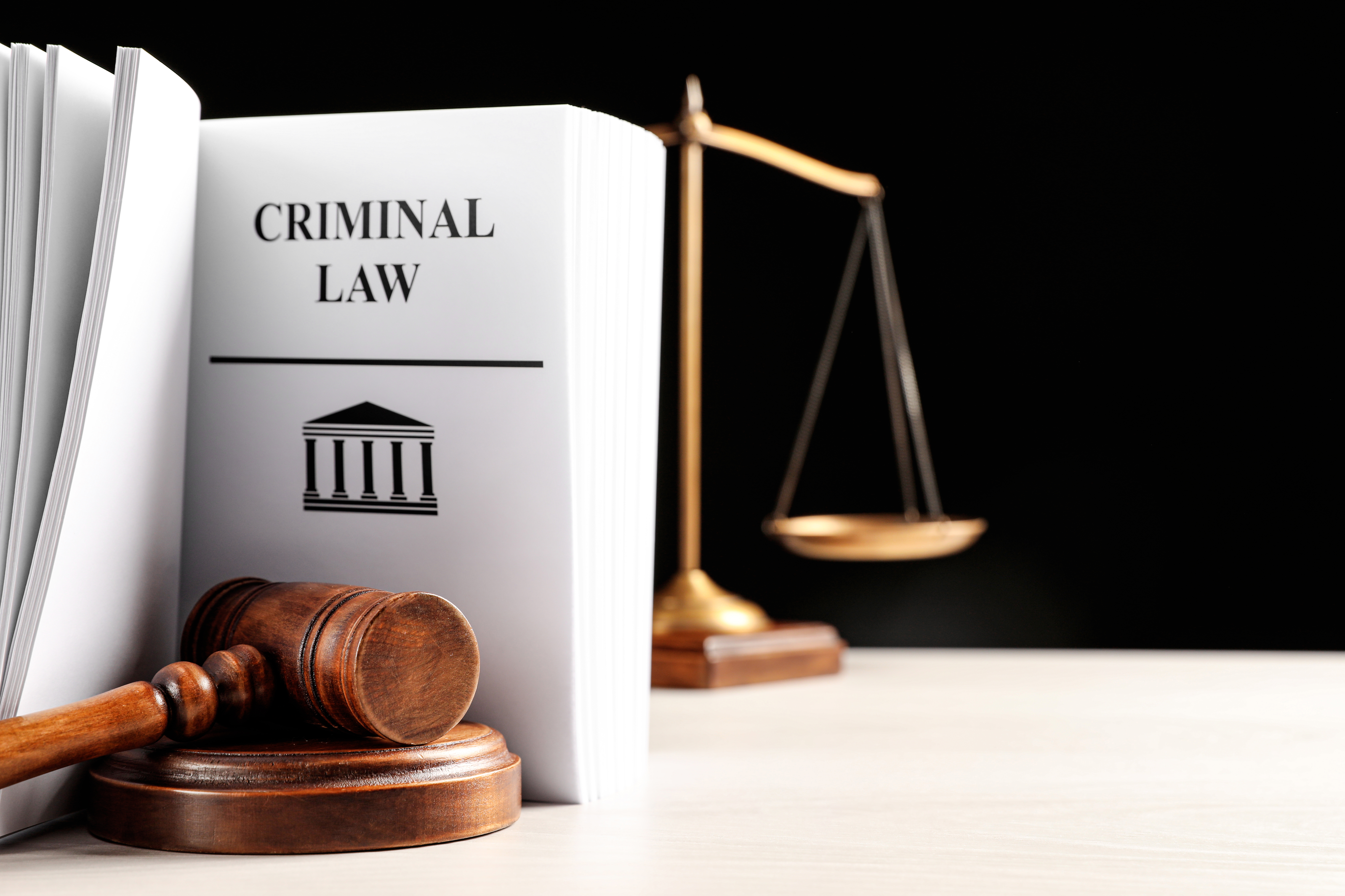 Open criminal law book with gavel and scales, symbolizing drug crime defense Tampa