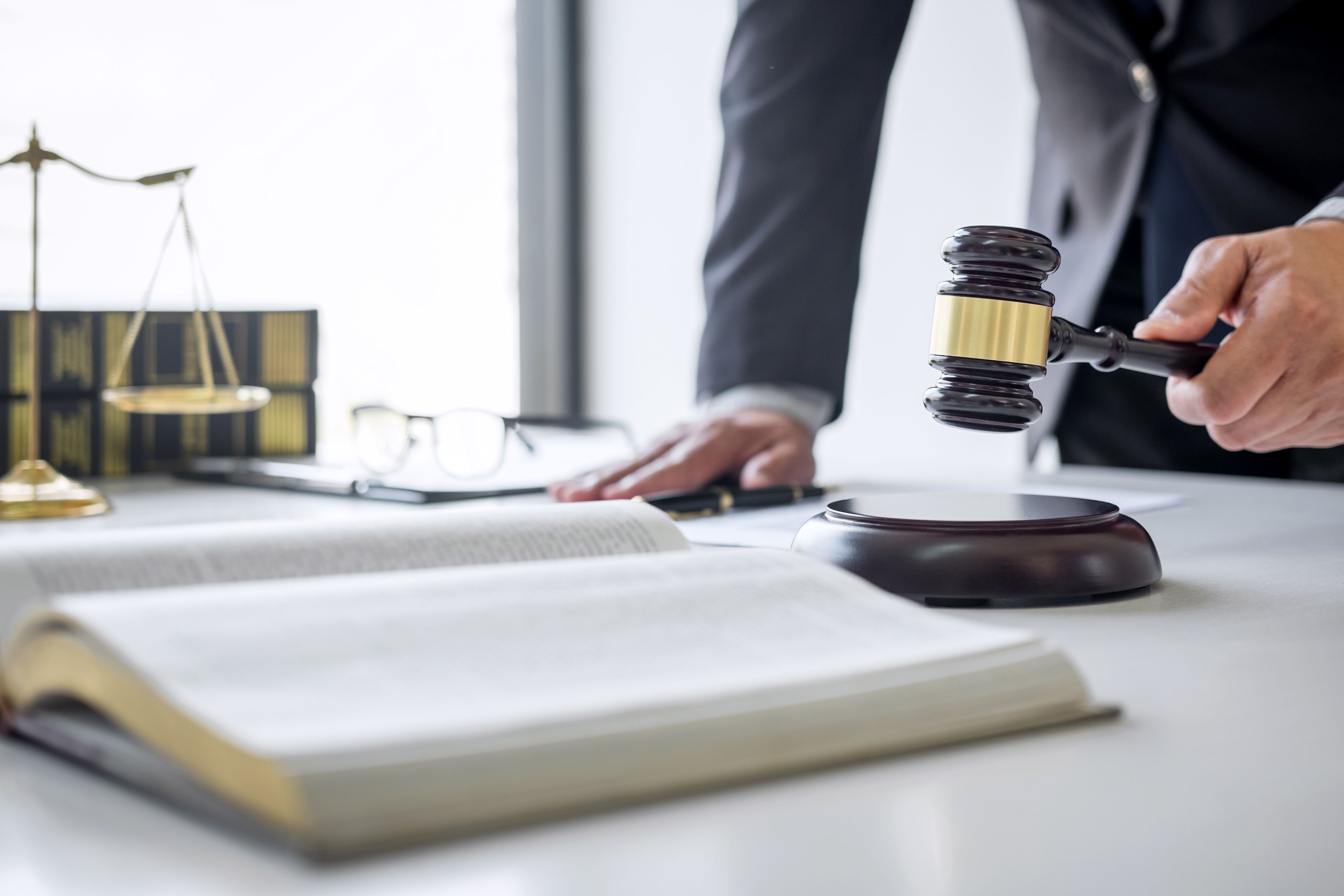 Wooden gavel poised near law books representing traffic ticket Tampa Florida legal process