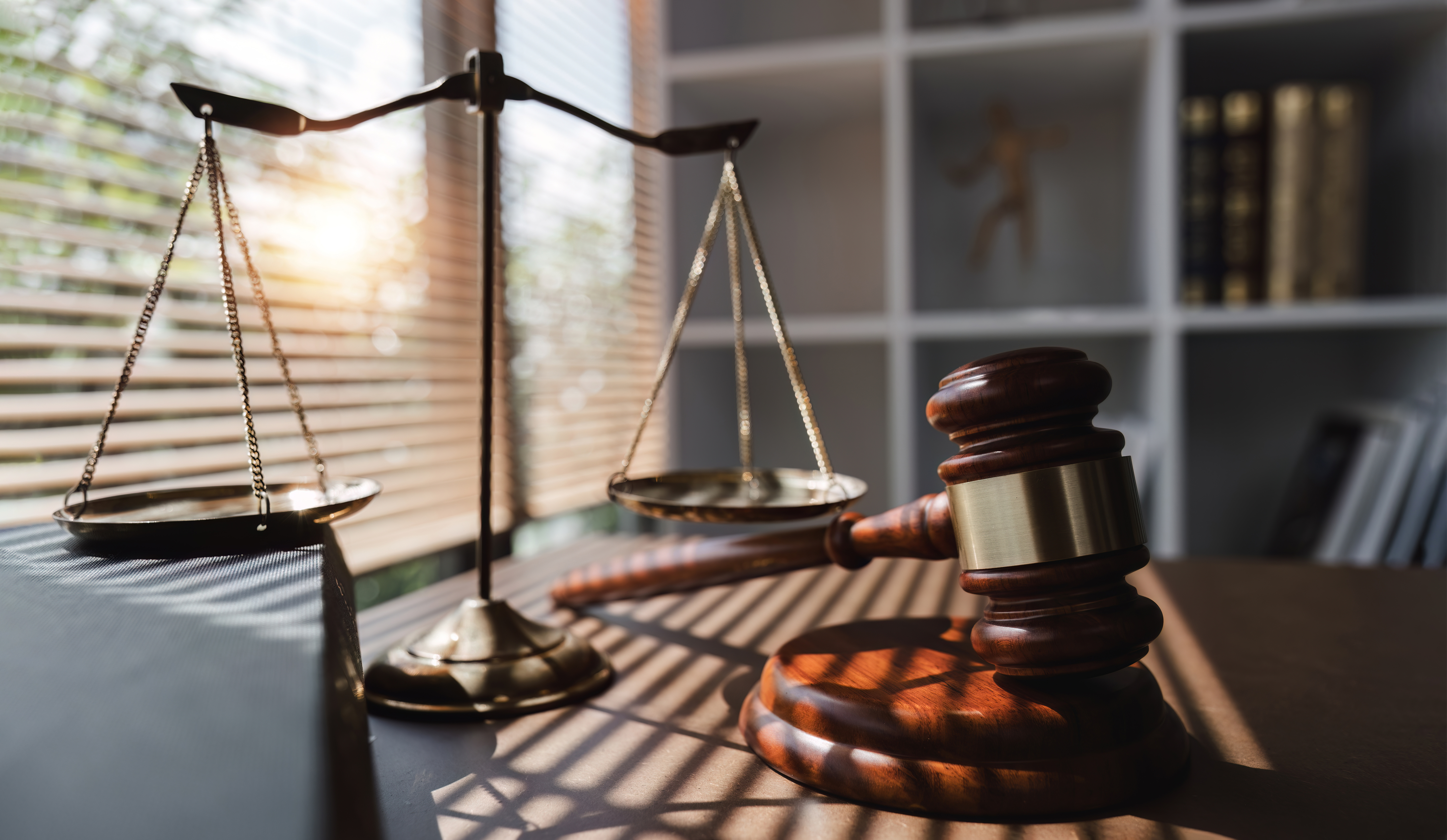 Legal scales and gavel representing car accidents Tampa summer liability claims